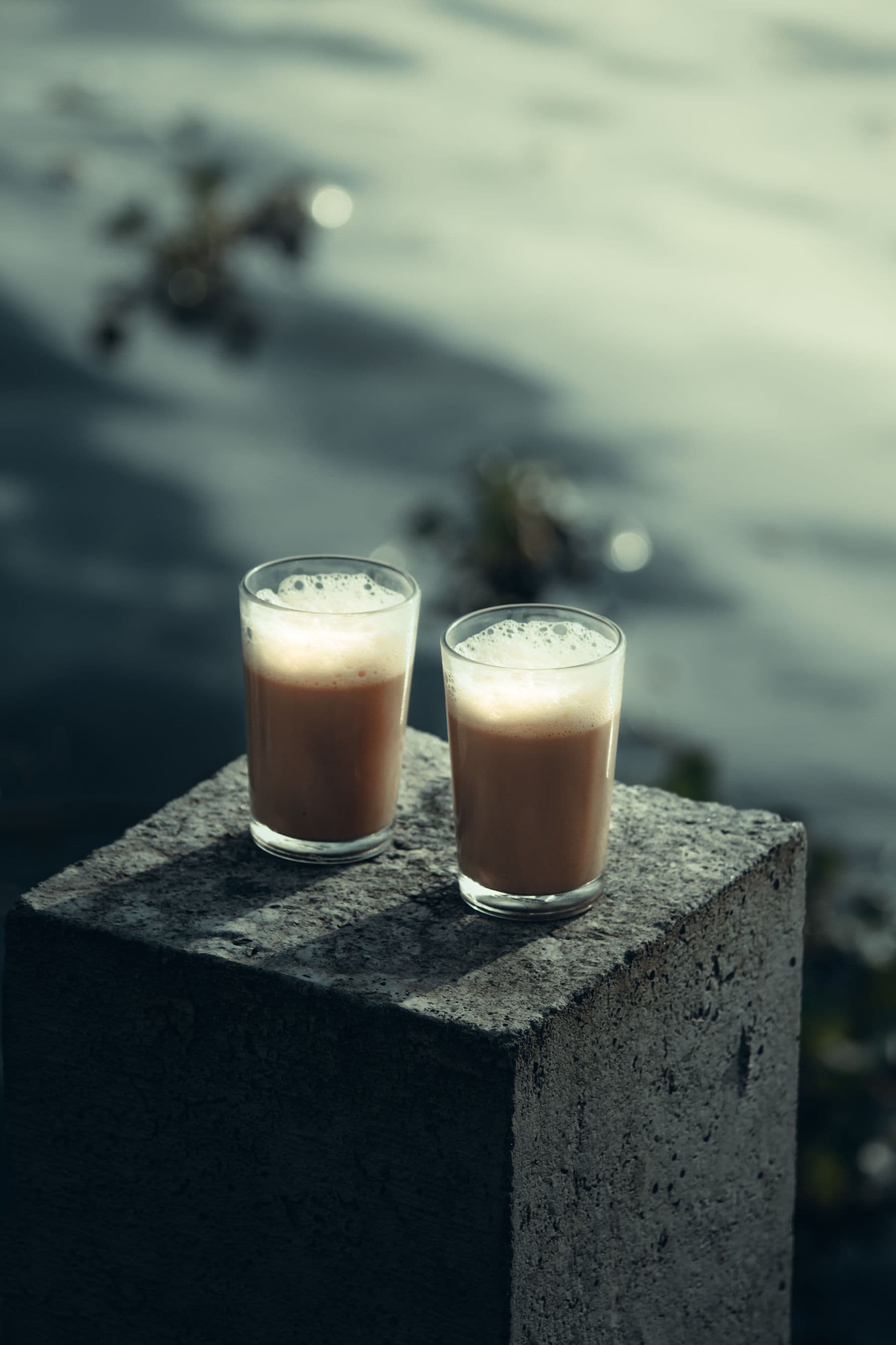 Two glasses of chai by still backwater